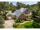 Brick home boasting a manicured lawn, side-entry garage, and beautifully landscaped grounds at 1317 Colonial Club Rd, Wake Forest, NC 27587
