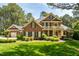 Beautiful two-story red brick home featuring a second story balcony and well-manicured front yard at 1317 Colonial Club Rd, Wake Forest, NC 27587