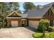 Spacious attached two-car garage with a concrete driveway, complemented by tasteful landscaping and a covered entrance at 1317 Colonial Club Rd, Wake Forest, NC 27587