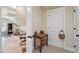 Hallway features neutral-colored walls and a table, leading into a cluttered room at 1317 Colonial Club Rd, Wake Forest, NC 27587