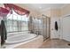 Main bathroom featuring a soaking tub and glass enclosed shower at 1317 Colonial Club Rd, Wake Forest, NC 27587