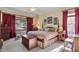 Bedroom featuring an upholstered bed, matching wood dressers, and carpet at 1317 Colonial Club Rd, Wake Forest, NC 27587