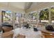 Relaxing screened porch with outdoor seating, a grill, and views of the surrounding greenery at 1317 Colonial Club Rd, Wake Forest, NC 27587