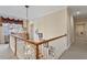 Well-lit stairwell with hardwood steps and white rails leads to an upper level at 1317 Colonial Club Rd, Wake Forest, NC 27587