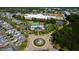 Wide aerial view of a neighborhood with a community center featuring a pool, tennis courts, and roundabout at 1322 Regulator St, Raleigh, NC 27603