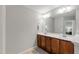 Bathroom with double sinks, wood cabinetry, and modern fixtures, offering ample counter space at 1322 Regulator St, Raleigh, NC 27603