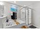 Bright bathroom features a white tiled tub and separate glass-enclosed shower, perfect for relaxation at 1322 Regulator St, Raleigh, NC 27603