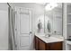 Bathroom featuring a single sink vanity with wood cabinets and a shower/tub with a neutral shower curtain at 1322 Regulator St, Raleigh, NC 27603