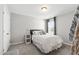 Cozy bedroom with neutral walls, carpeted floors, and a large window offering plenty of natural light at 1322 Regulator St, Raleigh, NC 27603