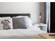 Bedroom close up featuring stylish pillows and cozy bedding against a modern headboard, creating a relaxing ambiance at 1322 Regulator St, Raleigh, NC 27603