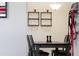 Dining room with hardwood floors, glass storage, and a modern light fixture at 1322 Regulator St, Raleigh, NC 27603