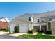 Townhouse complex featuring two-car garages and private entrances with manicured landscaping at 1322 Regulator St, Raleigh, NC 27603