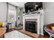 Cozy fireplace with mantel, complemented by a stylish rug and comfortable seating in a sunlit living space at 1322 Regulator St, Raleigh, NC 27603