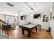Recreation area featuring a pool table, ample lighting, and seamless connectivity to the living area at 1322 Regulator St, Raleigh, NC 27603