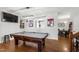 Spacious game room boasts a pool table, hockey decor, and open floorplan at 1322 Regulator St, Raleigh, NC 27603