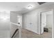 Well-lit hallway features neutral tones, carpeted floors, and multiple doorways leading to various rooms at 1322 Regulator St, Raleigh, NC 27603