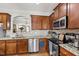 Kitchen features dark wood cabinets, stainless appliances, and granite countertops at 1322 Regulator St, Raleigh, NC 27603