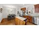 Kitchen featuring stainless steel appliances, dark cabinets, and an adjacent dining space at 1322 Regulator St, Raleigh, NC 27603