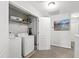 Functional laundry room equipped with washer, dryer, shelving, and ample space for efficient laundry tasks at 1322 Regulator St, Raleigh, NC 27603