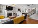 Open-concept living room featuring hardwood floors, fireplace, and seamless flow to recreation area at 1322 Regulator St, Raleigh, NC 27603