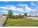 Fenced backyard featuring green lawn, landscaping, playground, and black and white fencing at 1410 Arena Ln, Fuquay Varina, NC 27526