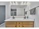 Bathroom featuring double vanity, framed glass shower, and natural lighting at 1410 Arena Ln, Fuquay Varina, NC 27526