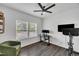 Bedroom with a black ceiling fan, hardwood floors, and a Peloton bike at 1410 Arena Ln, Fuquay Varina, NC 27526