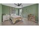 Bright bedroom with a playful dinosaur theme, carpet flooring, and a view to the neighborhood at 1410 Arena Ln, Fuquay Varina, NC 27526