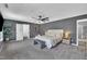 Bedroom with gray walls, carpet, and ample lighting with padded headboard bed at 1410 Arena Ln, Fuquay Varina, NC 27526