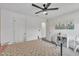 Bedroom with a floral quilt, ceiling fan, bright natural light and ample closet space at 1410 Arena Ln, Fuquay Varina, NC 27526