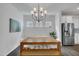 Modern dining room featuring a chandelier, stainless steel refrigerator, and dark hardwood floors at 1410 Arena Ln, Fuquay Varina, NC 27526