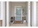 Inviting front porch features white columns, a storm door and a charming welcome mat at 1410 Arena Ln, Fuquay Varina, NC 27526