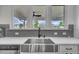 Kitchen sink has stainless steel faucet and undermount stainless sink and a window to a backyard view at 1410 Arena Ln, Fuquay Varina, NC 27526