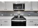 Stainless steel microwave and electric cooktop with oven in this well-appointed kitchen at 1410 Arena Ln, Fuquay Varina, NC 27526
