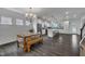 Open-concept kitchen and dining area featuring an eat-in kitchen island, pendant lights, and stainless steel appliances at 1410 Arena Ln, Fuquay Varina, NC 27526