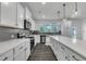 Spacious kitchen with island, stainless appliances, undermount sink and quartz counters at 1410 Arena Ln, Fuquay Varina, NC 27526