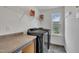 Well-lit laundry room with modern washer and dryer, a countertop, storage, and vinyl flooring at 1410 Arena Ln, Fuquay Varina, NC 27526