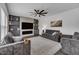 Cozy living room with fireplace, ceiling fan and stylish gray decor at 1410 Arena Ln, Fuquay Varina, NC 27526