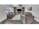 Living room features modern decor, large windows, ceiling fan and an open concept to the kitchen at 1410 Arena Ln, Fuquay Varina, NC 27526
