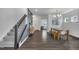 Bright living room with hardwood floors, featuring a staircase and an open floor plan at 1410 Arena Ln, Fuquay Varina, NC 27526