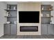 Living room with built-in shelving and cabinets surrounding an electric fireplace at 1410 Arena Ln, Fuquay Varina, NC 27526