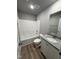 Clean bathroom with shower-tub combo, neutral vanity, and wood-look floor at 146 Starry Sky Dr, Benson, NC 27504