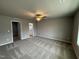 Serene bedroom featuring plush carpeting, a ceiling fan, and a view into an ensuite bathroom at 146 Starry Sky Dr, Benson, NC 27504