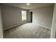 Cozy bedroom with neutral carpet and paint, as well as a view of the outdoors at 146 Starry Sky Dr, Benson, NC 27504