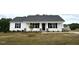 Charming single-story home with white siding and a well-manicured lawn on a cloudy day at 146 Starry Sky Dr, Benson, NC 27504