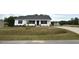 Charming single-story home with white siding and a well-manicured lawn on a cloudy day at 146 Starry Sky Dr, Benson, NC 27504