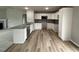 Modern kitchen featuring white cabinets, stainless steel appliances, and stylish gray backsplash at 146 Starry Sky Dr, Benson, NC 27504