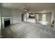 Open-concept living area with gray walls, plush carpeting, and a kitchen with modern appliances at 146 Starry Sky Dr, Benson, NC 27504