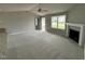 Spacious living room with gray walls, plush carpet, and a cozy fireplace with mantel at 146 Starry Sky Dr, Benson, NC 27504