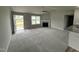 Bright living room with a fireplace, grey walls, carpet and large window with natural light at 146 Starry Sky Dr, Benson, NC 27504